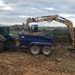 CATERPILLAR 302.7 putting dirt into trailer