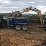 CATERPILLAR 5 305.5E2CR emptying dirt into trailer