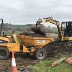 dirt being emptied into thwaites - bucket swival